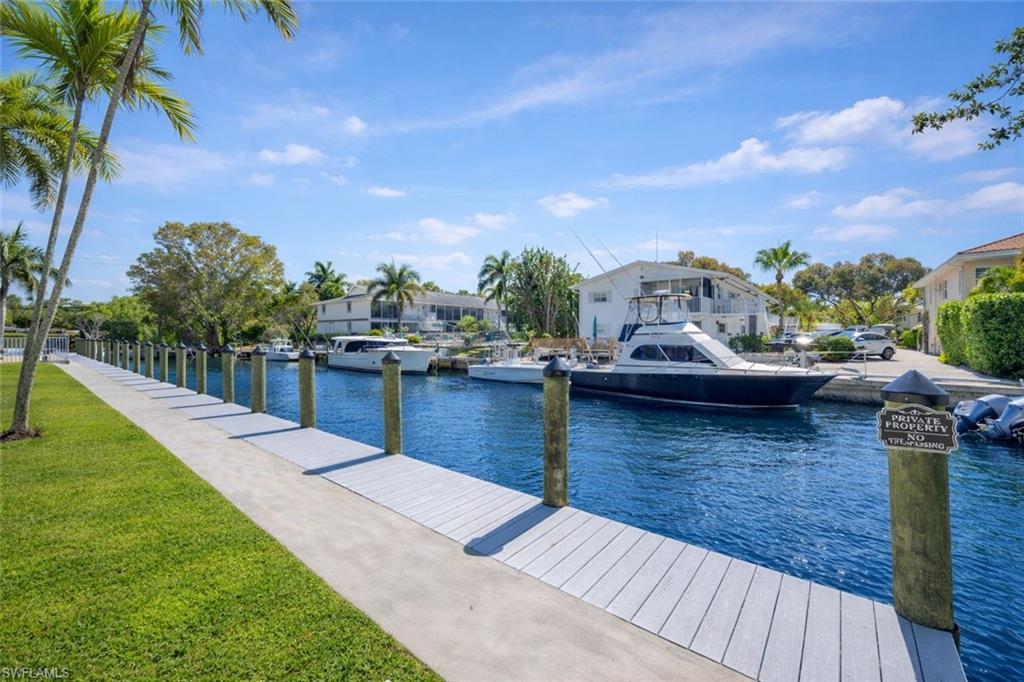 1686 Blue Point Avenue, Unit B5 Naples, FL 34102 - Photo 20 of 46 a view of a lake with houses