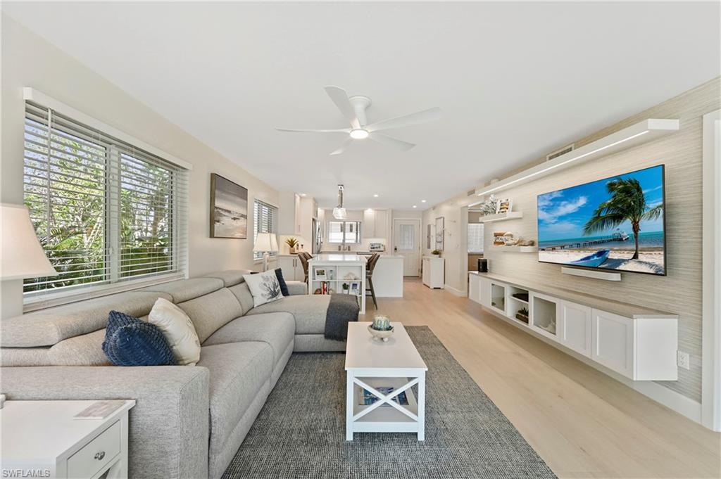 1686 Blue Point Avenue, Unit B5 Naples, FL 34102 - Photo 22 of 46 a living room with furniture and a flat screen tv