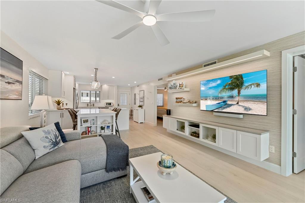 1686 Blue Point Avenue, Unit B5 Naples, FL 34102 - Photo 23 of 46 a living room with furniture and a flat screen tv