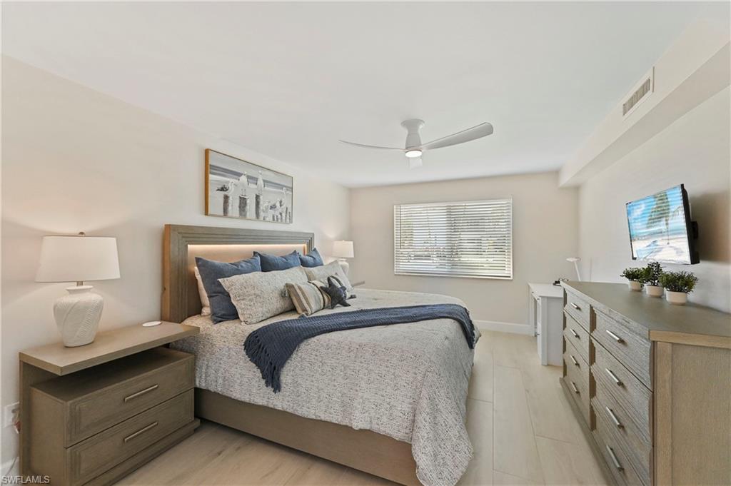1686 Blue Point Avenue, Unit B5 Naples, FL 34102 - Photo 24 of 46 a bed room with a bed window and a television