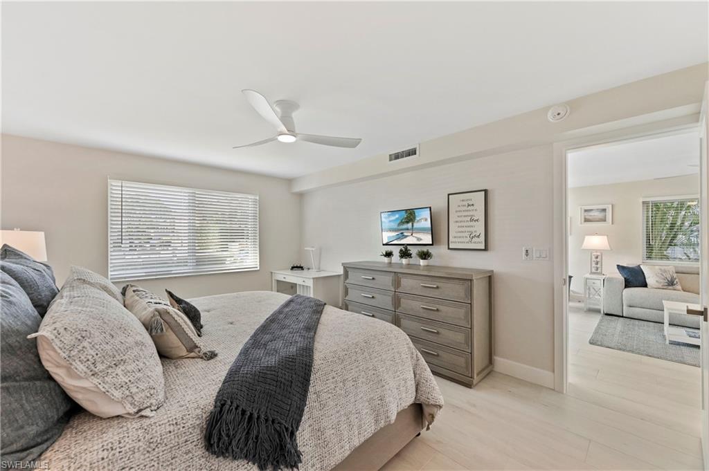 1686 Blue Point Avenue, Unit B5 Naples, FL 34102 - Photo 25 of 46 a spacious bedroom with a large bed and a couch