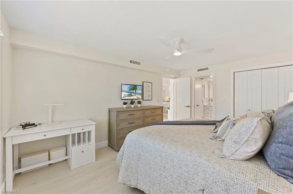 1686 Blue Point Avenue, Unit B5 Naples, FL 34102 - Photo 28 of 46 a bedroom with a bed and a couch