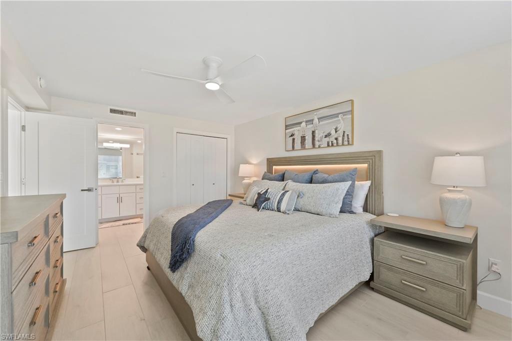1686 Blue Point Avenue, Unit B5 Naples, FL 34102 - Photo 29 of 46 a bedroom with a bed and a lamp
