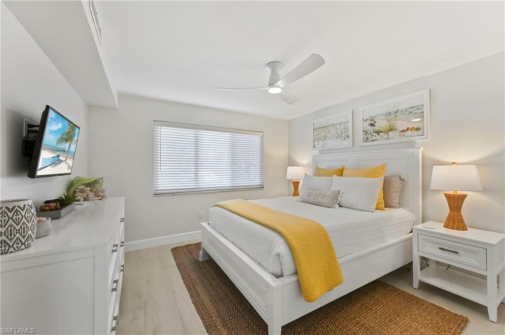 1686 Blue Point Avenue, Unit B5 Naples, FL 34102 - Photo 30 of 46 a bedroom with a bed and a flat screen tv