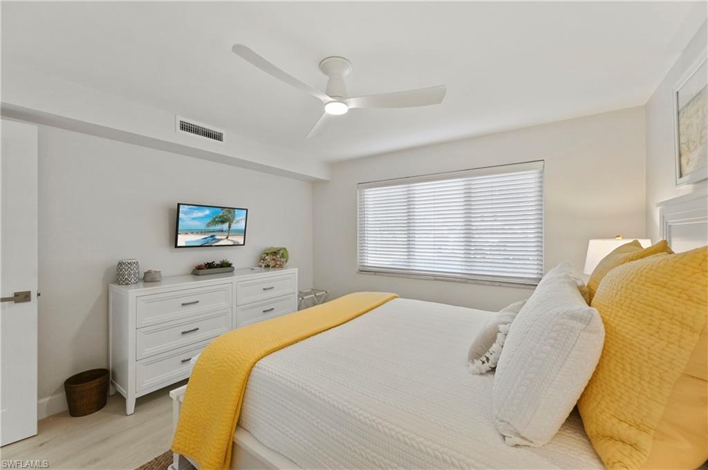 1686 Blue Point Avenue, Unit B5 Naples, FL 34102 - Photo 31 of 46 a spacious bedroom with a bed and a window