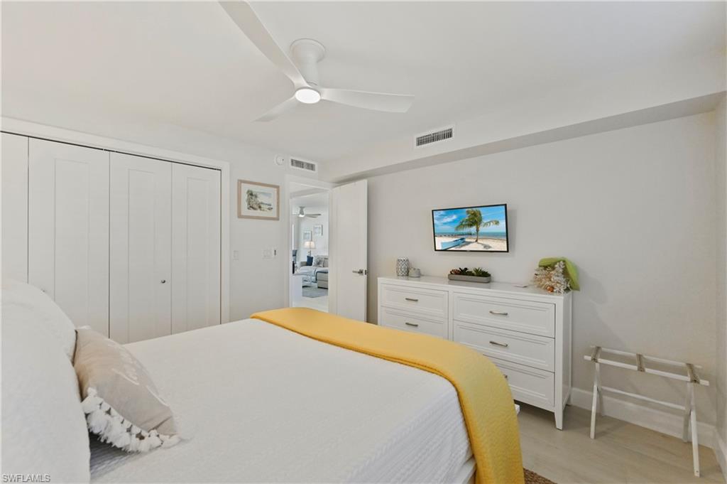 1686 Blue Point Avenue, Unit B5 Naples, FL 34102 - Photo 32 of 46 a bedroom with a bed and furniture