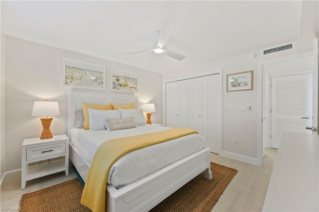 1686 Blue Point Avenue, Unit B5 Naples, FL 34102 - Photo 33 of 46 a bedroom with a bed and a lamp