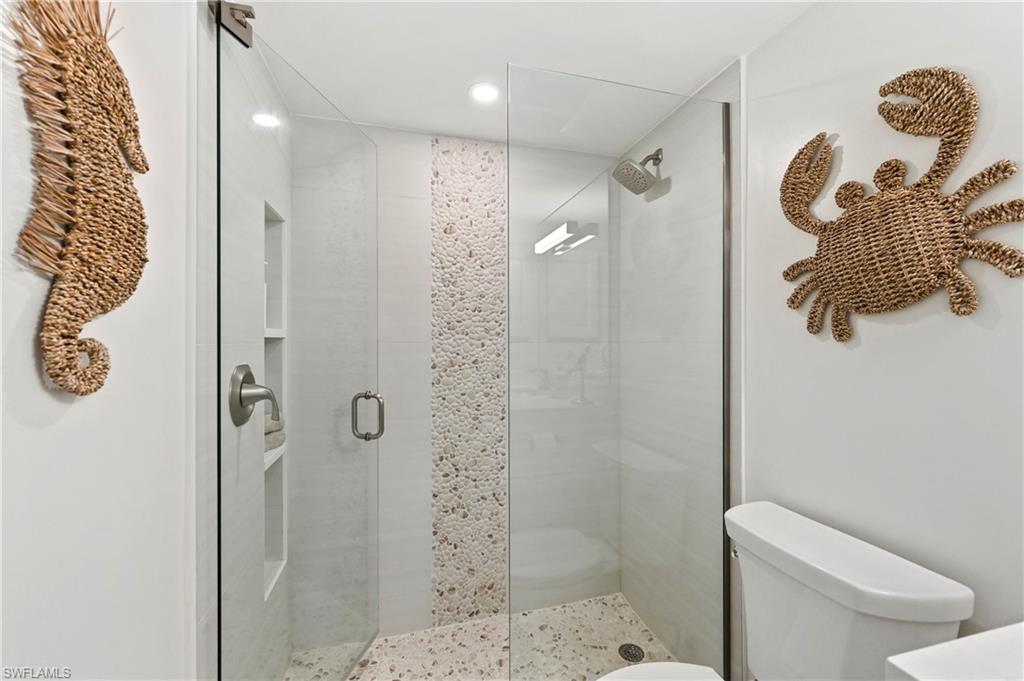 1686 Blue Point Avenue, Unit B5 Naples, FL 34102 - Photo 34 of 46 a bathroom with a shower a toilet and a sink