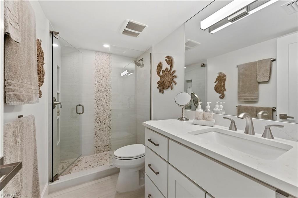 1686 Blue Point Avenue, Unit B5 Naples, FL 34102 - Photo 35 of 46 a bathroom with a sink a toilet and shower