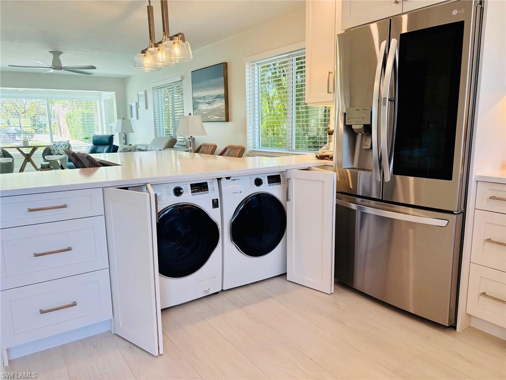 1686 Blue Point Avenue, Unit B5 Naples, FL 34102 - Photo 8 of 46 a kitchen with cabinets and stainless steel appliances