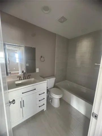 a bathroom with a double vanity sink toilet and shower