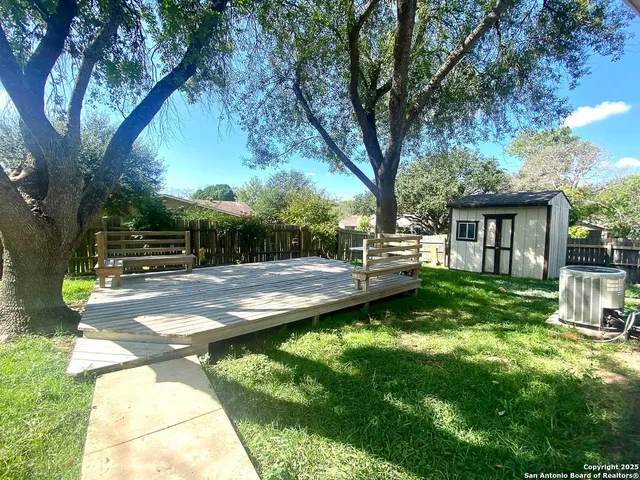 a view of a backyard with sitting area