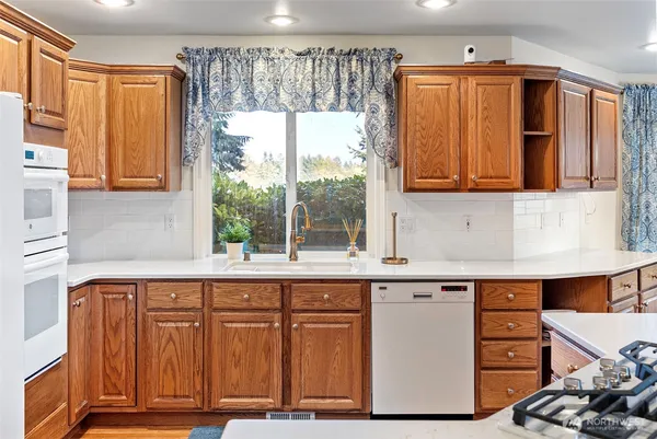 a kitchen with a sink a refrigerator and window