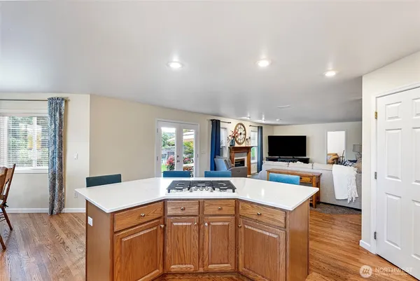 a kitchen that has a lot of cabinets and wooden floor