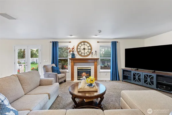 a living room with furniture a fireplace and a flat screen tv