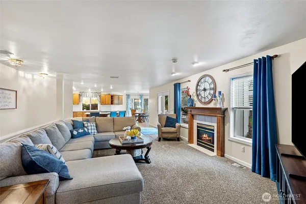 a living room with furniture a fireplace and a flat screen tv