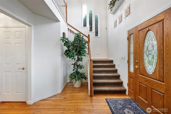 a view of entryway with wooden floor and stairs