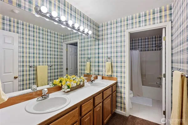 a bathroom with a sink double vanity and shower