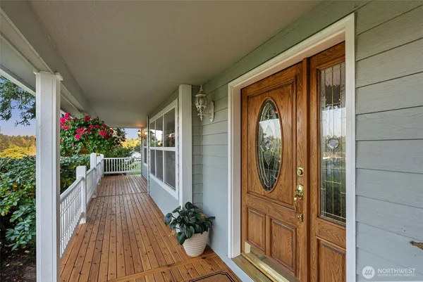 a view of a house with porch and flowers