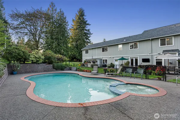a view of a house with swimming pool and sitting area
