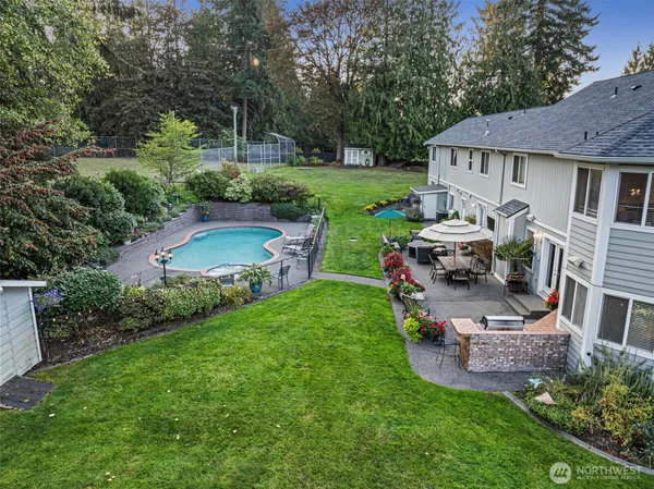 a view of a house with backyard sitting area and garden