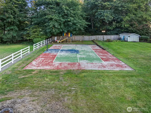a small pool is sitting in the grass near a house