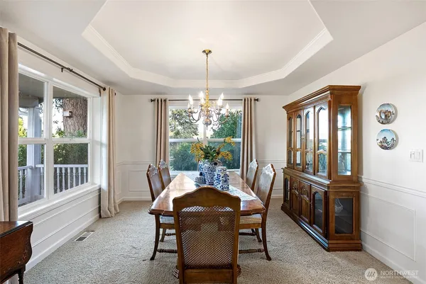 a view of a dining room with furniture large windows and wooden floor