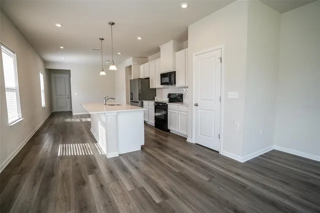 a kitchen with stainless steel appliances a refrigerator sink and cabinets