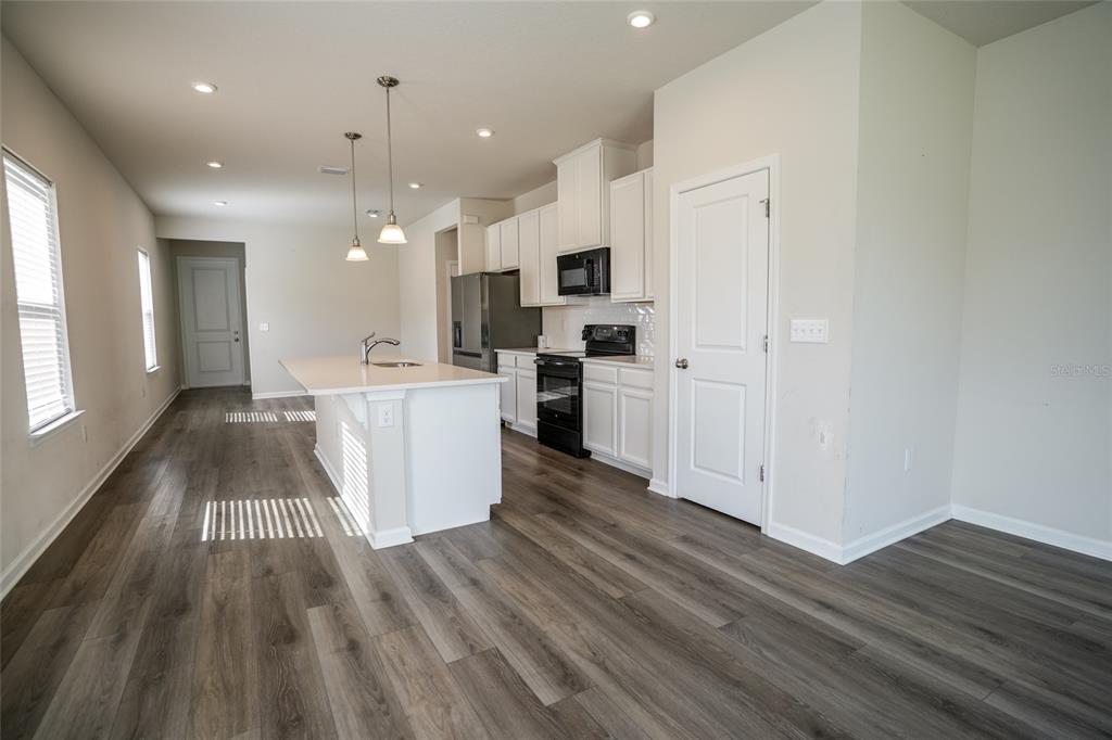 8606 Bonfire Way Parrish, FL 34219 - Photo 3 of 9 a kitchen with stainless steel appliances a refrigerator sink and cabinets