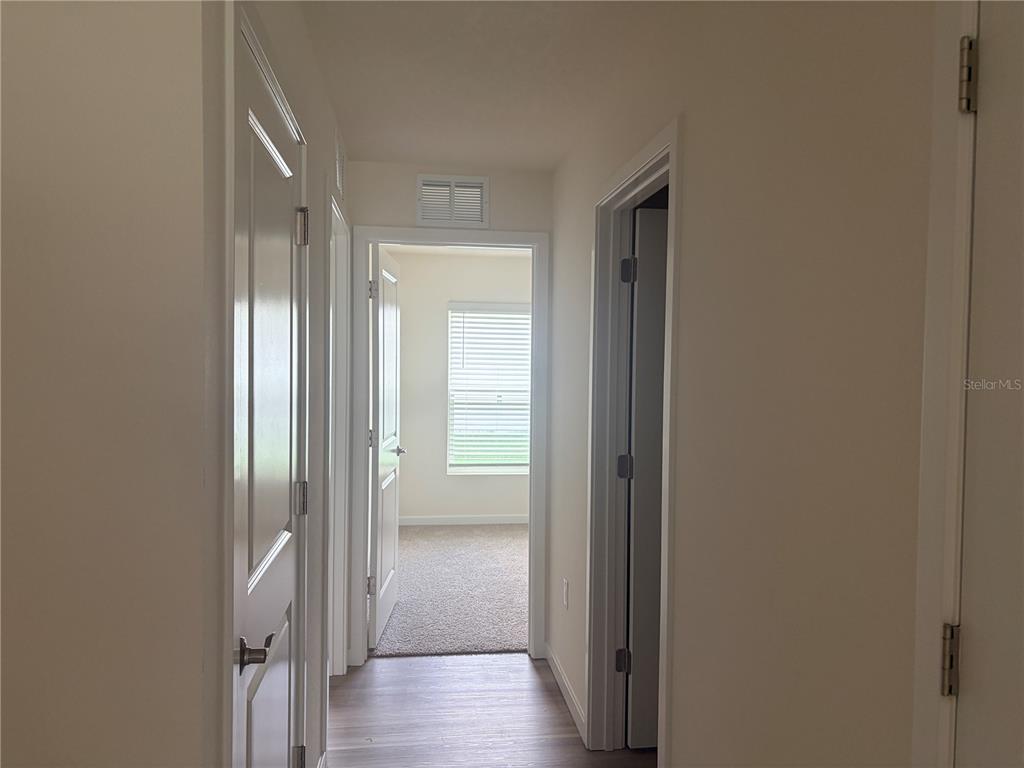 15886 Southeast 101st Ct Road Summerfield, FL 34491 - Photo 12 of 14 a view of a hallway with wooden floor