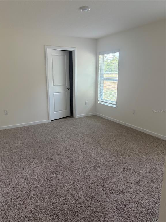 15886 Southeast 101st Ct Road Summerfield, FL 34491 - Photo 6 of 14 a view of an empty room with a window