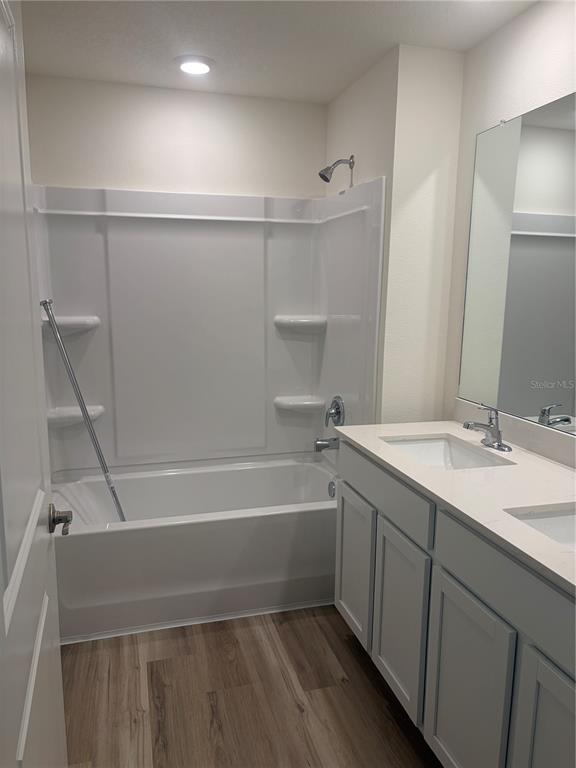15886 Southeast 101st Ct Road Summerfield, FL 34491 - Photo 8 of 14 a bathroom with a tub sink and mirror