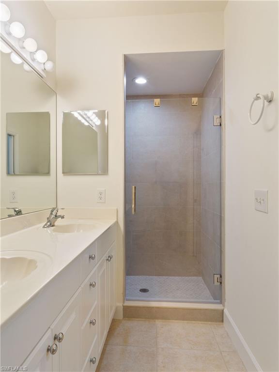 445 Robin Hood Circle, Unit 202 Naples, FL 34104 - Photo 13 of 23 a bathroom with a shower and a sink