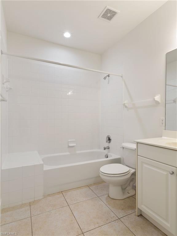 445 Robin Hood Circle, Unit 202 Naples, FL 34104 - Photo 16 of 23 a bathroom with a toilet a sink and a bathtub