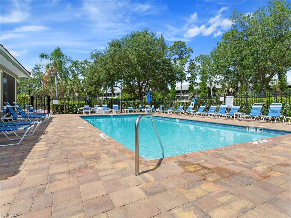 445 Robin Hood Circle, Unit 202 Naples, FL 34104 - Photo 21 of 23 a view of swimming pool with chairs