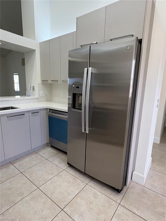 445 Robin Hood Circle, Unit 202 Naples, FL 34104 - Photo 8 of 23 a kitchen with cabinets and stainless steel appliances