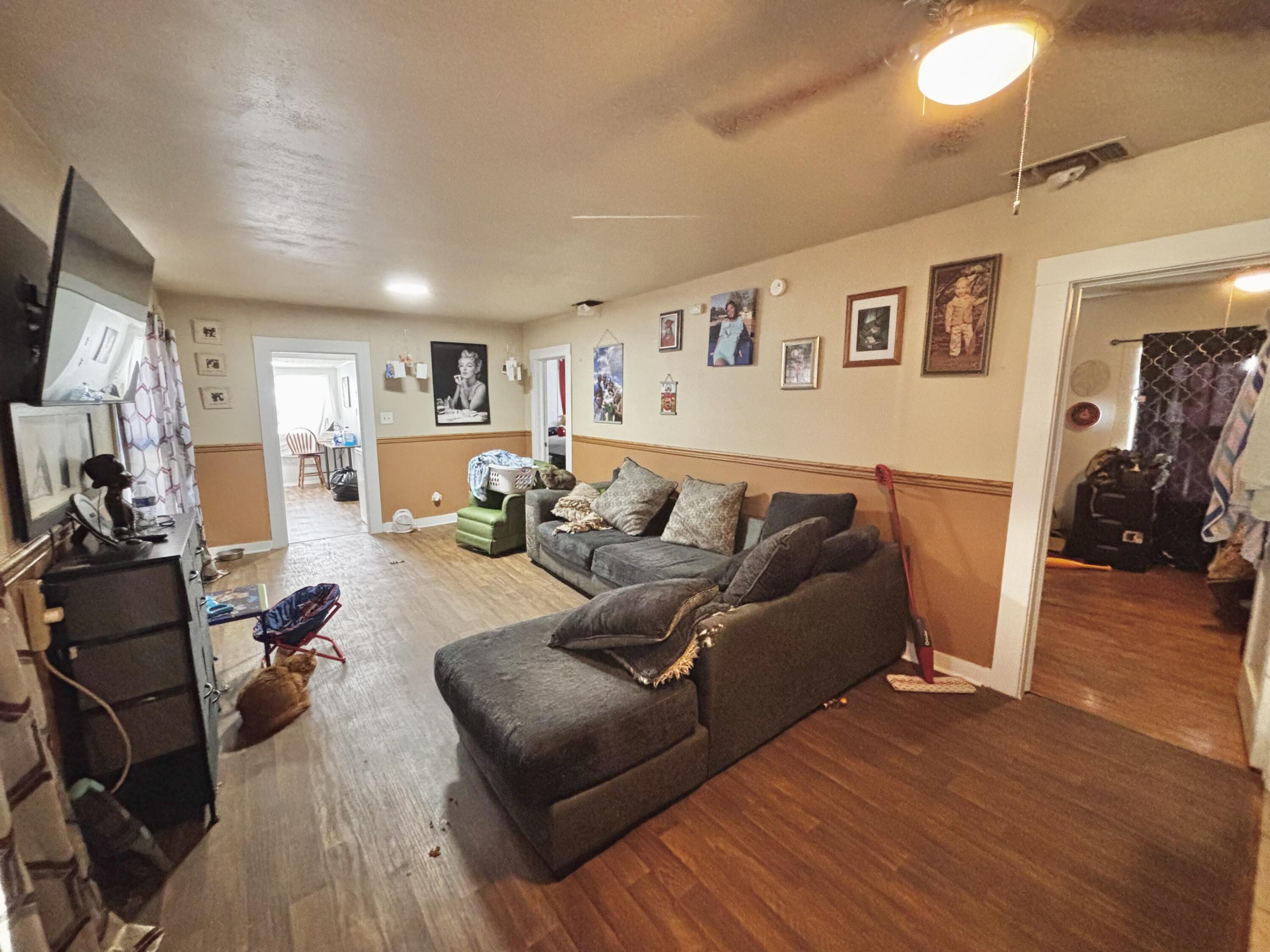 720 South 11th Street Slaton, TX 79364 - Photo 16 of 32 a living room with furniture or couch and a flat screen tv