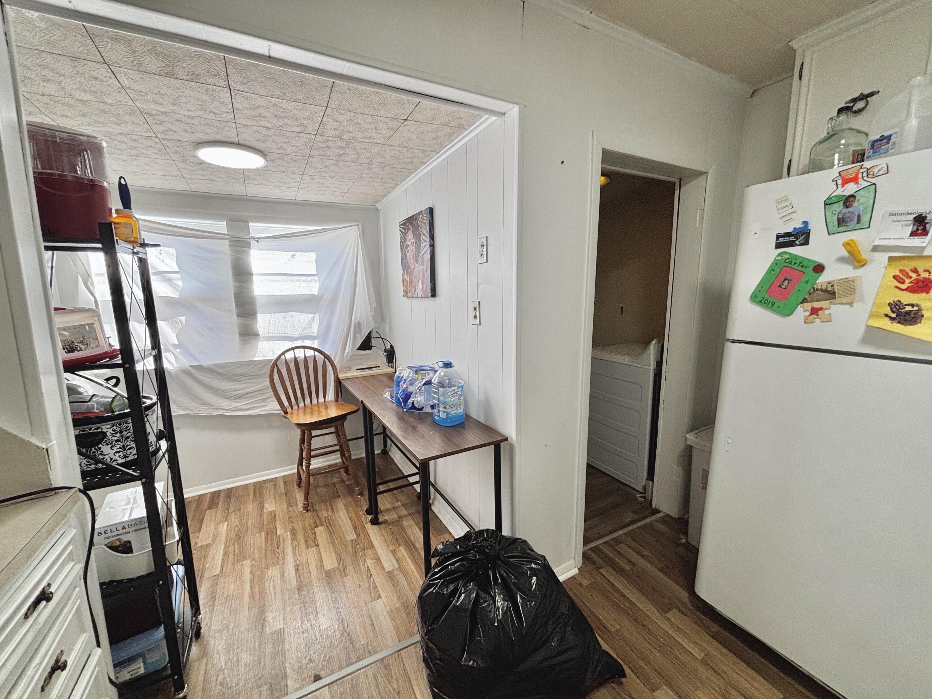 720 South 11th Street Slaton, TX 79364 - Photo 20 of 32 a hallway with a dining table and chairs