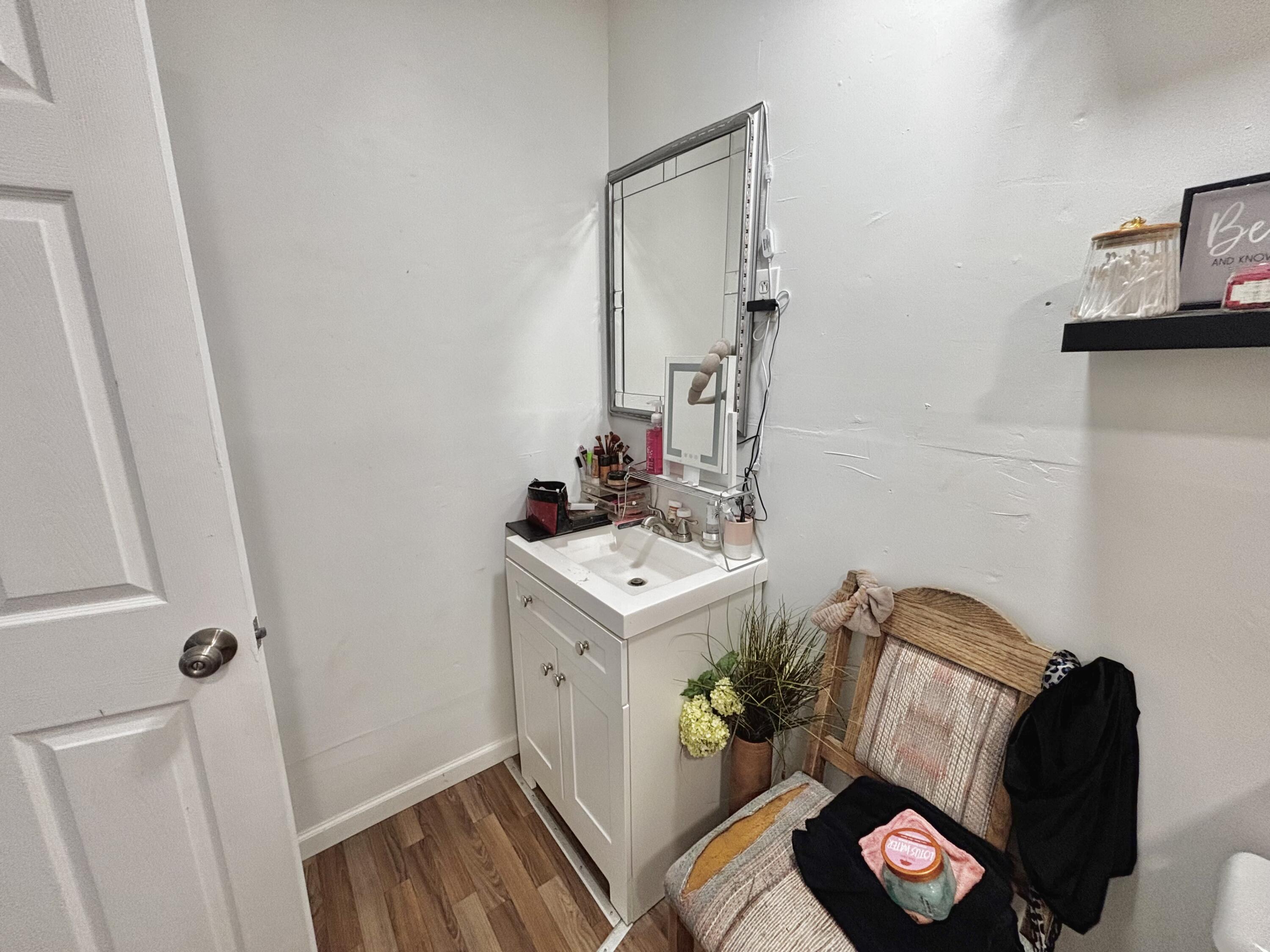720 South 11th Street Slaton, TX 79364 - Photo 29 of 32 a living room with furniture and a wooden floor
