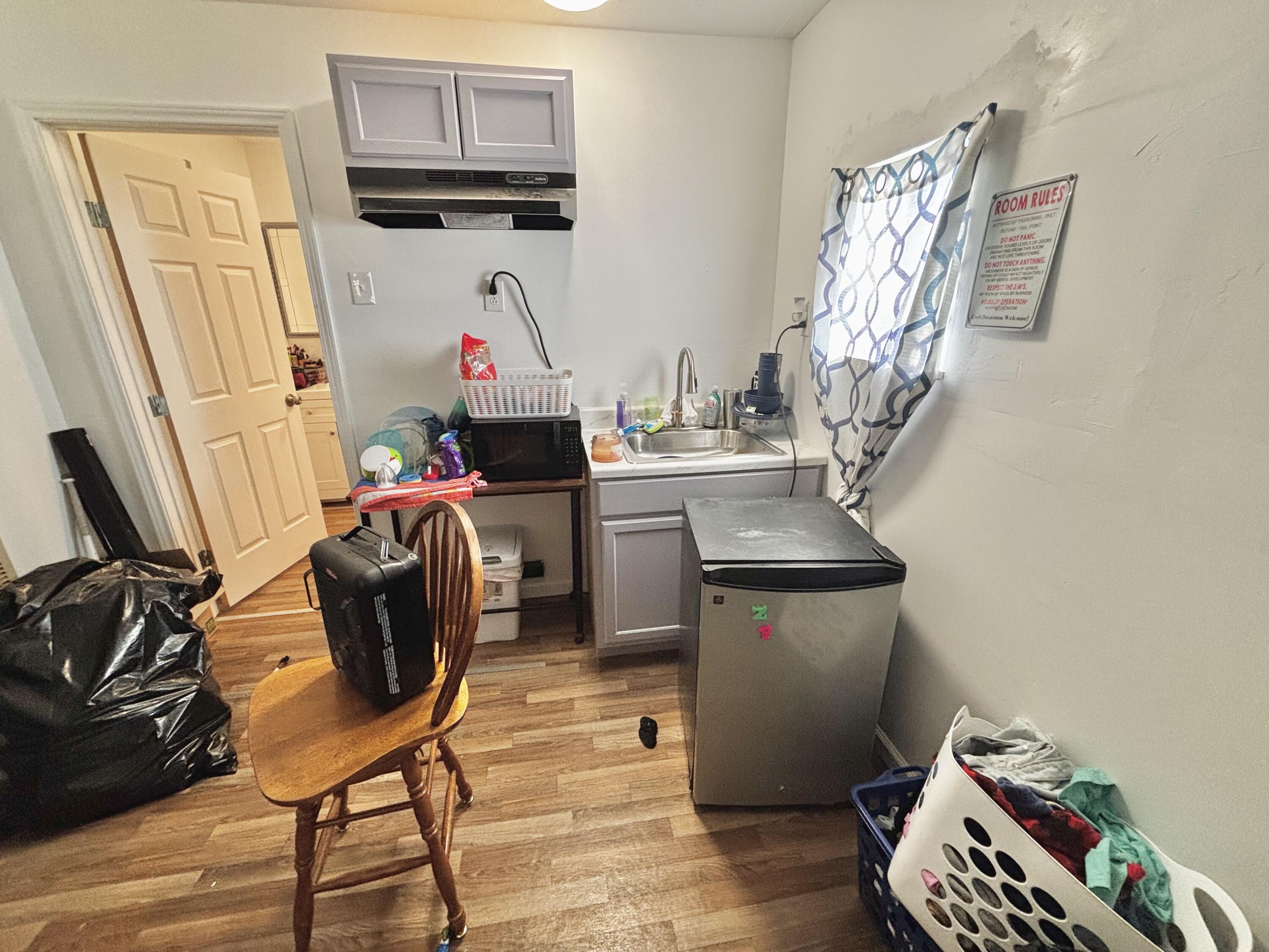 720 South 11th Street Slaton, TX 79364 - Photo 32 of 32 a room with furniture and wooden floor