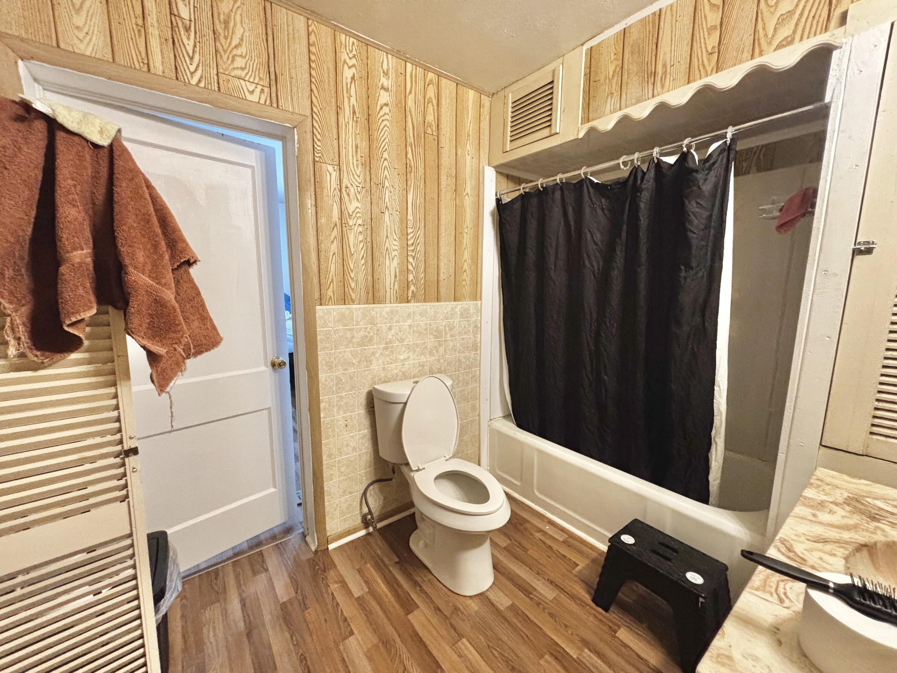 720 South 11th Street Slaton, TX 79364 - Photo 8 of 32 a bathroom with a toilet and a shower