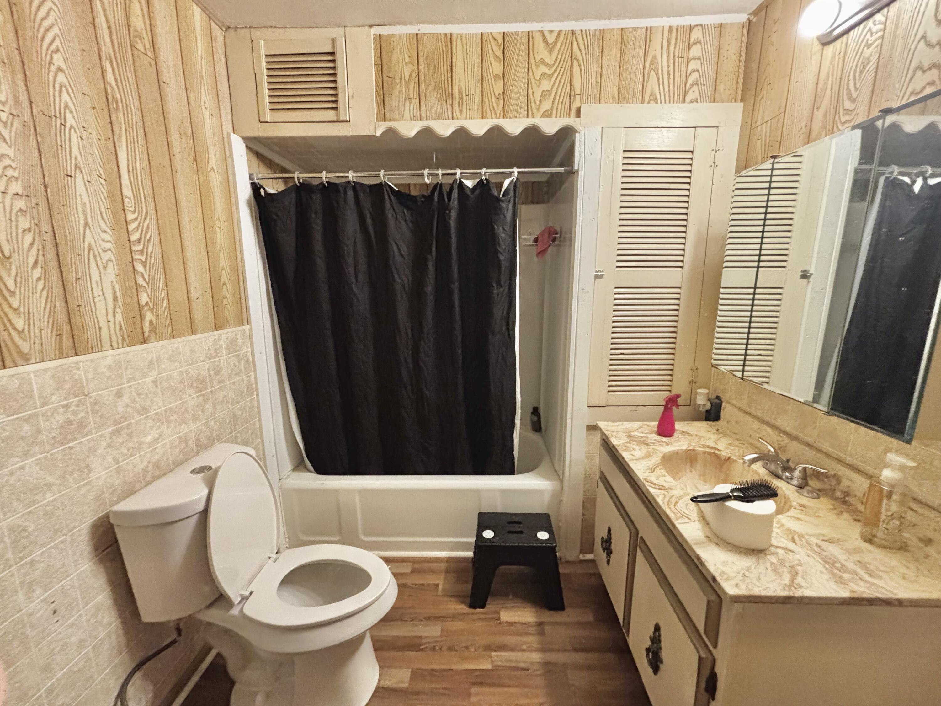 720 South 11th Street Slaton, TX 79364 - Photo 9 of 32 a bathroom with a sink and a mirror