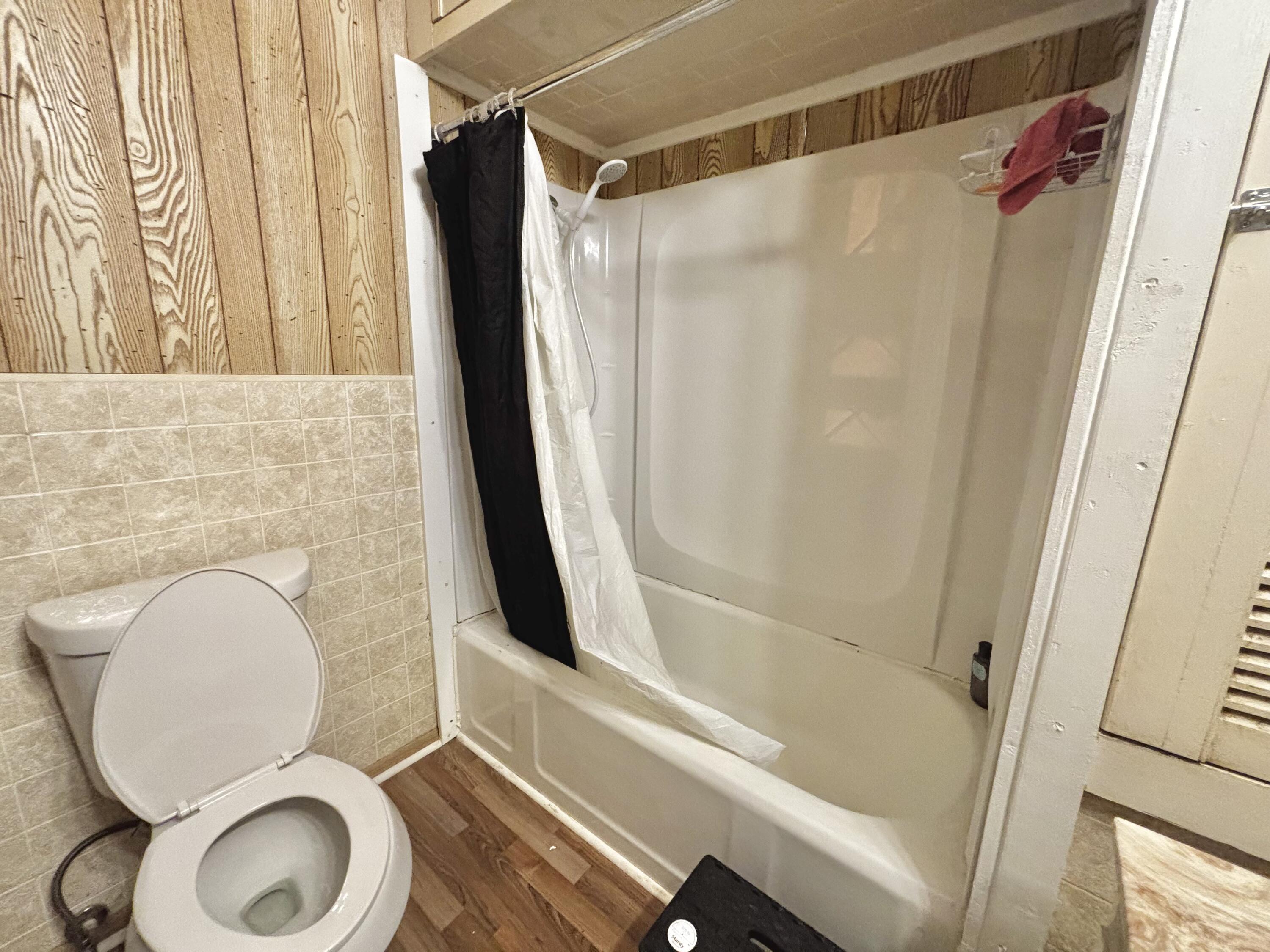 720 South 11th Street Slaton, TX 79364 - Photo 10 of 32 a bathroom with a toilet and a shower