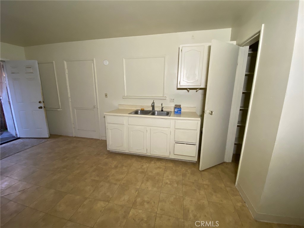 1190 South K Street Oxnard, CA 93033 - Photo 26 of 43 a kitchen with white cabinets and white appliances