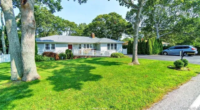 a view of a house with a yard and sitting area
