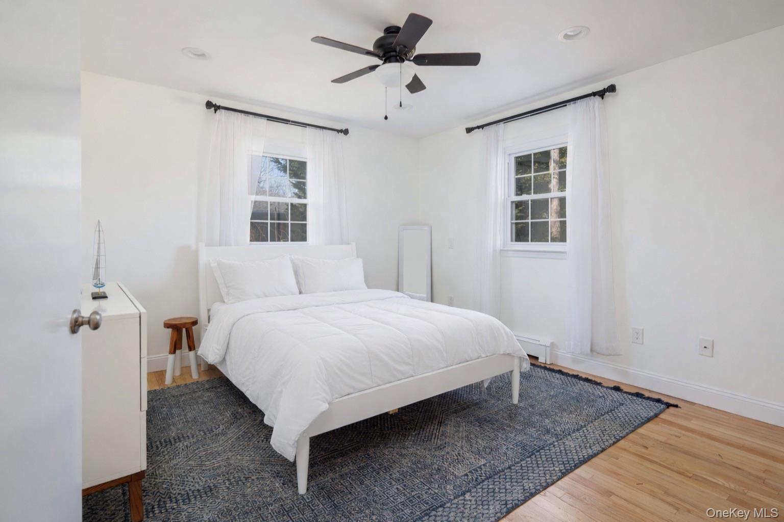 129 Lynncliff Road Hampton Bays, NY 11946 - Photo 11 of 24 a bedroom with a bed and window