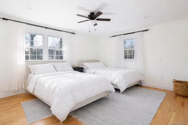 a spacious bedroom with two beds and a chandelier