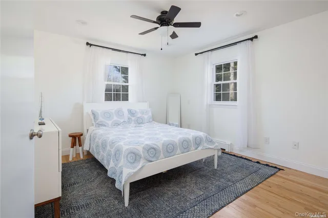 a spacious bedroom with a bed and a window