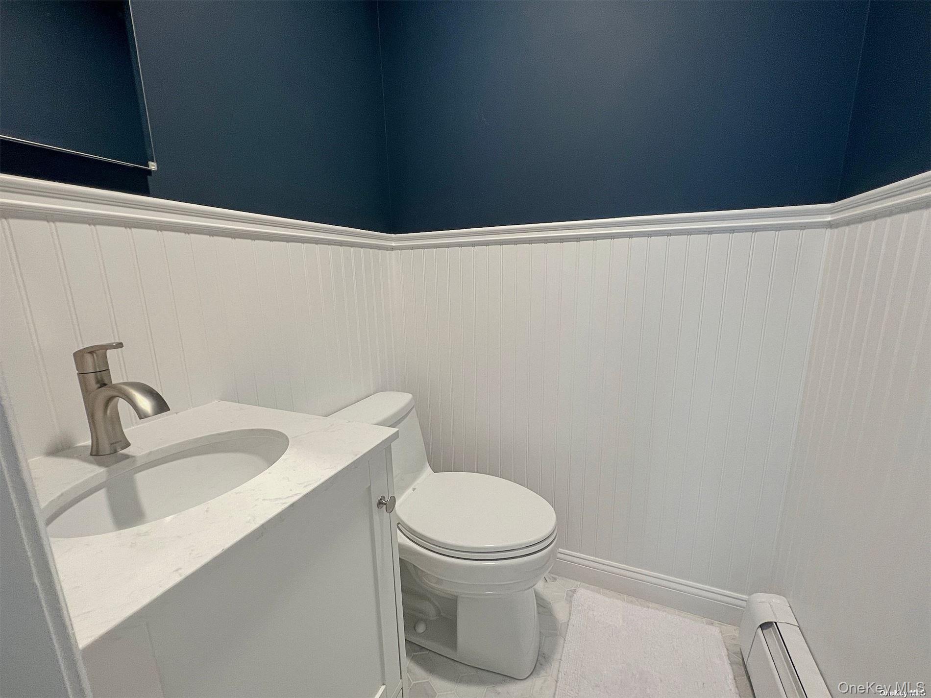 129 Lynncliff Road Hampton Bays, NY 11946 - Photo 14 of 24 a bathroom with a toilet and sink