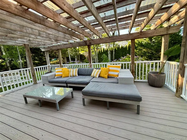 a outdoor space with the couches and dining table with the garden view